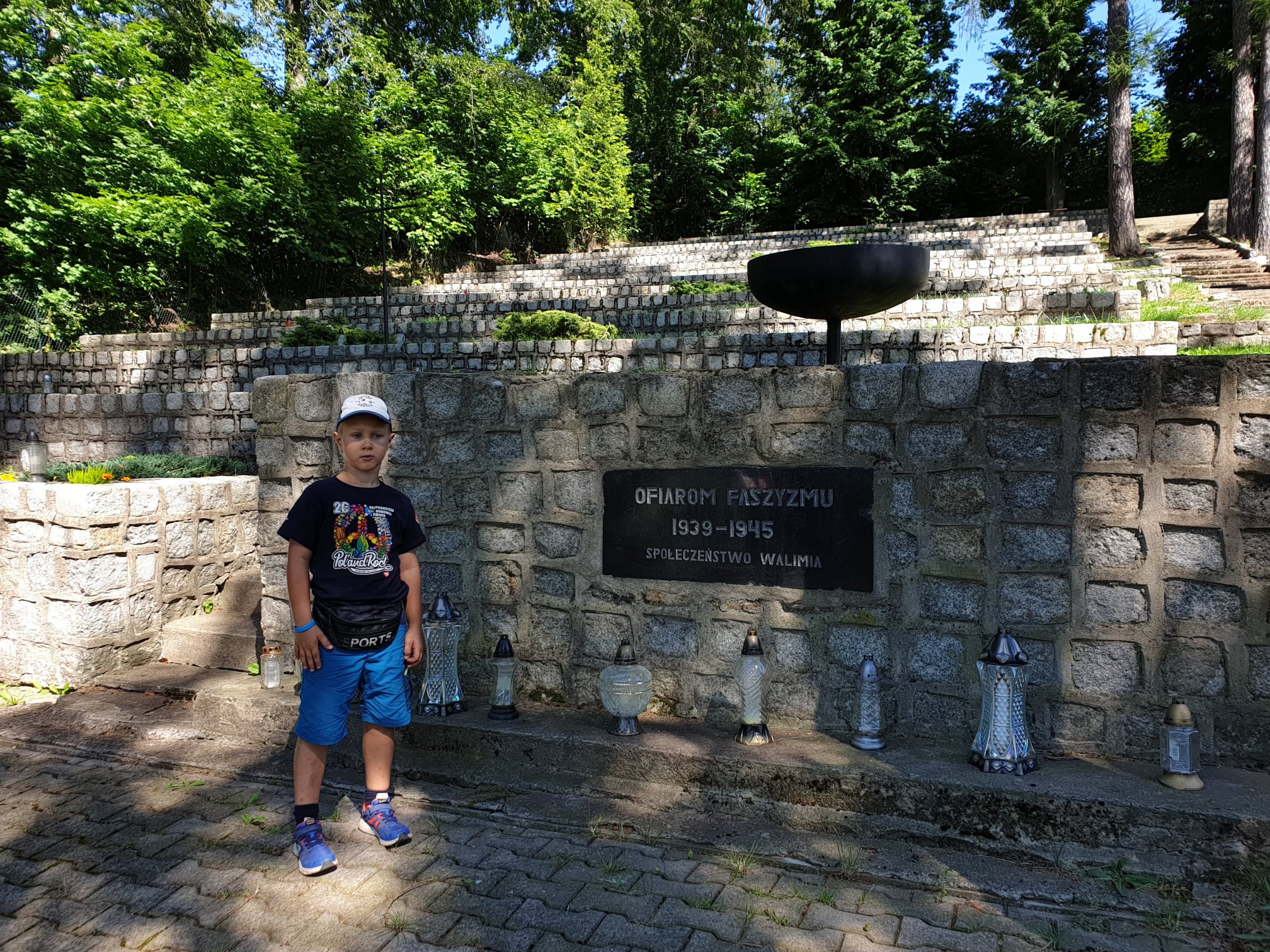 Kwatera ofiar faszyzmu w Walimiu z tablicą i zniczami